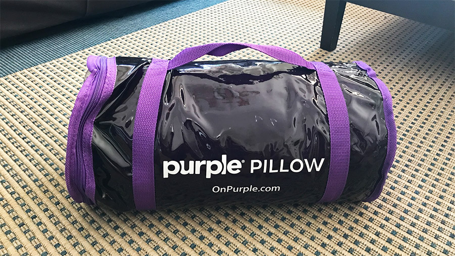 Purple Pillow in cylindrical bag.